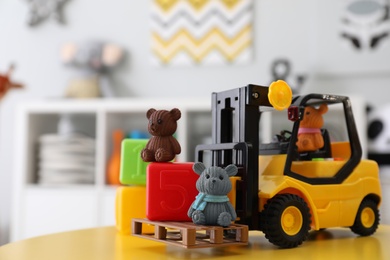 Photo of Toy stacker and cubes on table in child's room, closeup. Space for text