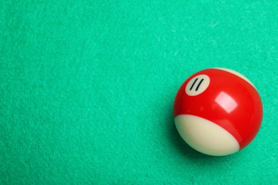 Billiard ball with number 11 on green table, top view. Space for text