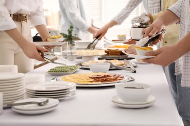 Photo of People taking food during breakfast, closeup. Buffet service