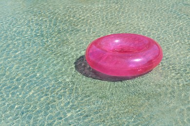 Bright inflatable ring floating on sea water. Space for text