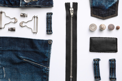 Photo of Composition with garment accessories and cutting details for jeans isolated on white, top view