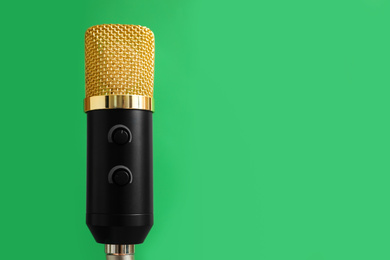 Microphone on green background, space for text. Journalist's work