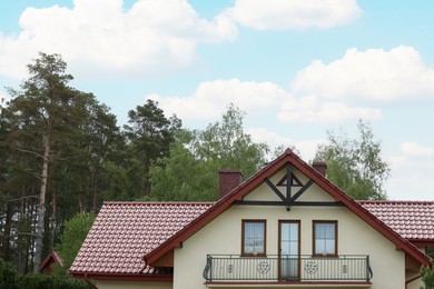Modern building with red roof outdoors on spring day