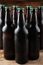Photo of Many bottles of beer on wooden table
