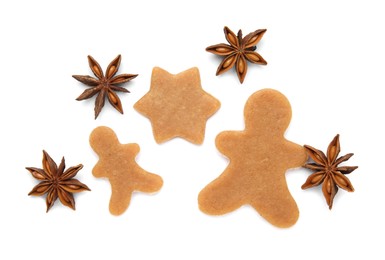 Unbaked Christmas cookies and anise on white background, top view