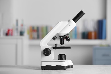 Modern medical microscope on white table in laboratory