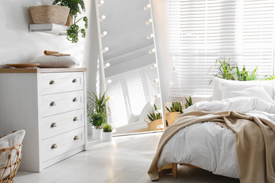 White chest of drawers in beautiful bedroom. Interior design