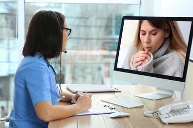 Hotline service. Doctor consulting patient online via computer indoors