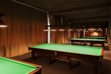 Photo of Empty green billiard tables in club. Pool Game