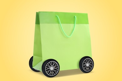 Green shopping bag on wheels against yellow background. Delivery service