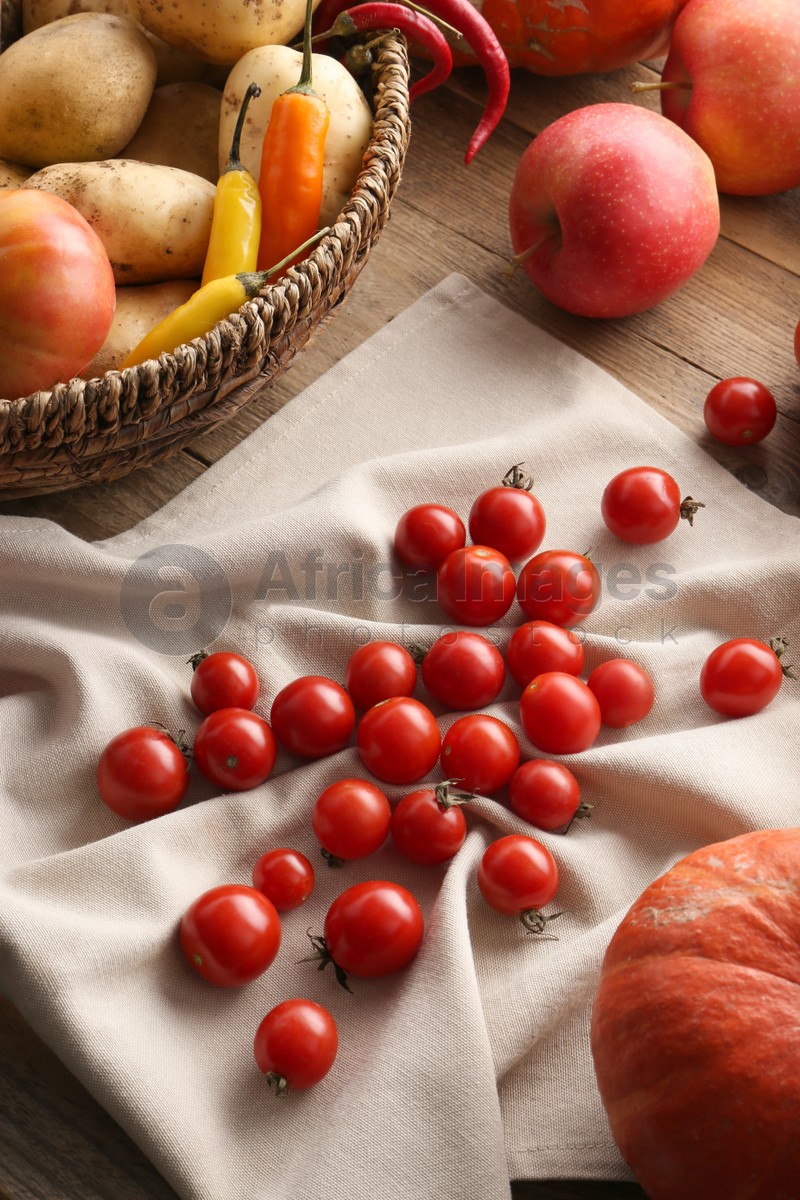 Photo of Different fresh ripe vegetables, berries and fruits on wooden table. Farmer produce