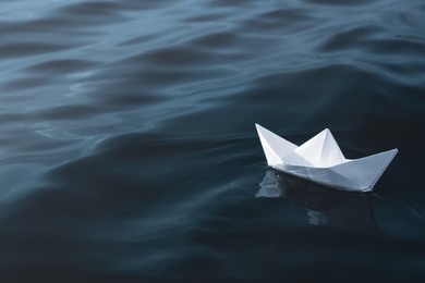 White paper boat floating on river, space for text