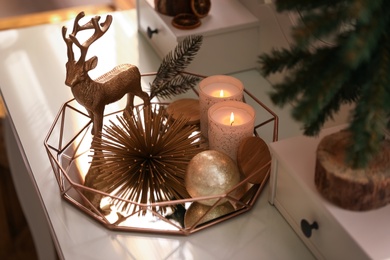 Composition with decorative reindeer and Christmas tree on dressing table, closeup