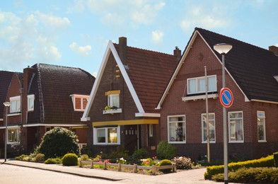 Photo of Block of houses on sunny day. Suburban district