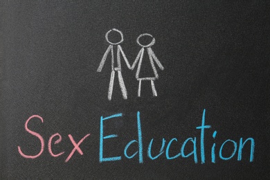 Phrase "SEX EDUCATION" written on black chalkboard