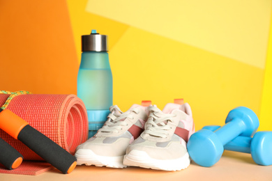 Photo of Composition with fitness equipment on light table