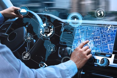 Image of Man using navigation system while driving car, closeup
