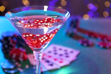 Cocktail with casino dice in glass on table, closeup. Space for text