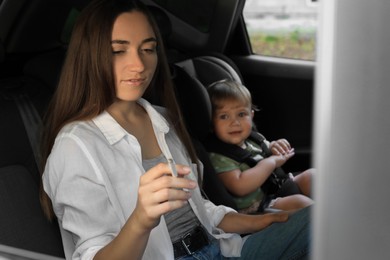 Mother with cigarette and child in car. Don't smoke near kids
