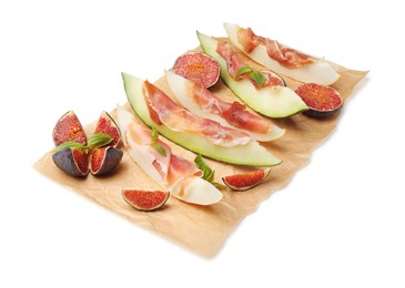 Photo of Parchment with tasty melon, jamon and figs isolated on white