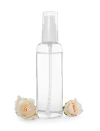 Bottle of micellar cleansing water and flowers on white background