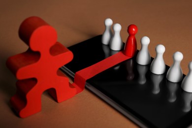 Photo of Recruitment process, job competition concept. Red pawn among white ones as best applicant chosen by human figure on light brown background