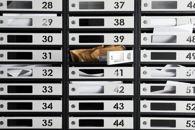 Many mailboxes with keyholes, numbers and correspondence as background