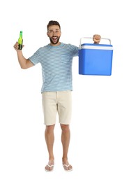 Happy man with cool box and bottle of beer on white background