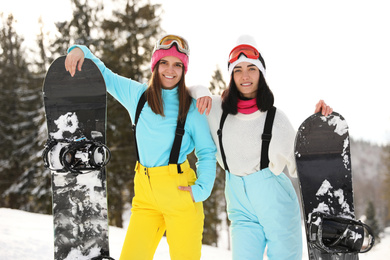 Young snowboarders wearing winter sport clothes outdoors