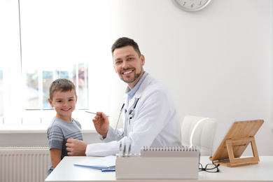 Children's doctor working with little patient in clinic