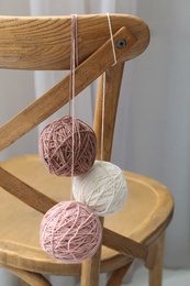 Soft woolen yarns hanging on chair indoors