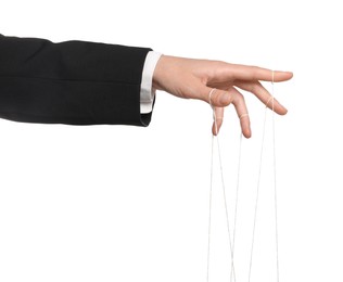 Woman pulling strings of puppet on white background, closeup