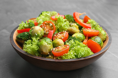 Tasty salad with Brussels sprouts on grey table