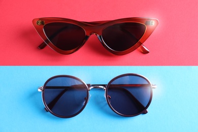 Stylish sunglasses on color background, flat lay