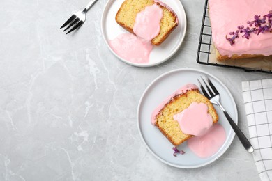 Delicious cake with pink glaze served on light marble table, flat lay. Space for text