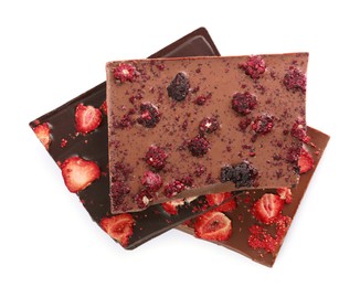 Photo of Halves of chocolate bars with freeze dried berries on white background, top view
