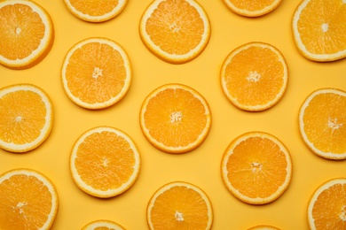 Fresh orange slices on color background, top view