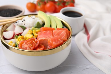 Photo of Delicious poke bowl with salmon, avocado and vegetables on white textured table, closeup. Space for text