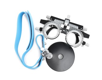 Photo of Trial frame and head mirror on white background, top view. Ophthalmologist tools