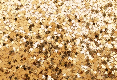 Confetti stars as background,  top view. Christmas celebration
