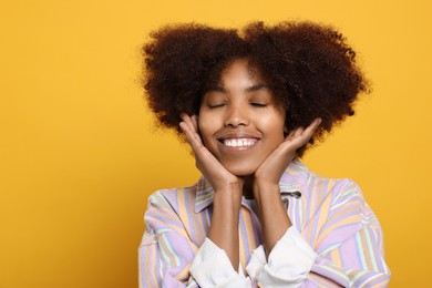 Photo of Portrait of smiling African American woman on orange background