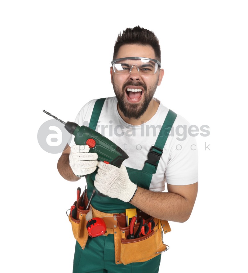 Emotional worker in uniform with power drill on white background