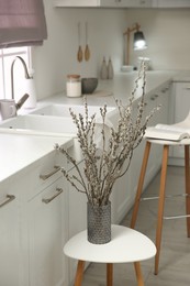 Beautiful blooming pussy willow branches in kitchen