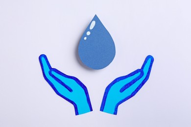 Photo of Save Water concept. Paper hands and drop on white background, flat lay