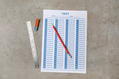 Photo of Answer sheet, pencil and ruler on light grey table, flat lay. Student passing exam