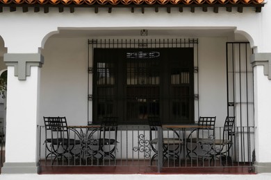 Photo of Exterior of beautiful cafe with terrace, chairs and tables