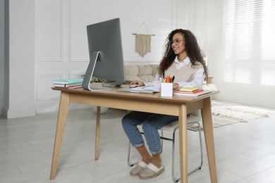 African American woman using modern computer for studying at home. Distance learning