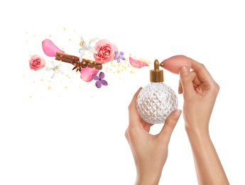 Woman holding bottle of perfume with floral scent on white background, closeup
