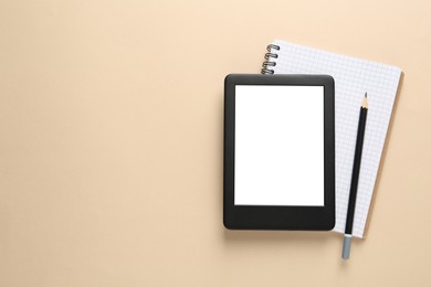 Modern e-book reader, notebook and pencil on beige background, top view. Space for text