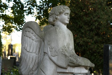 Beautiful statue of angel at cemetery. Religious symbol